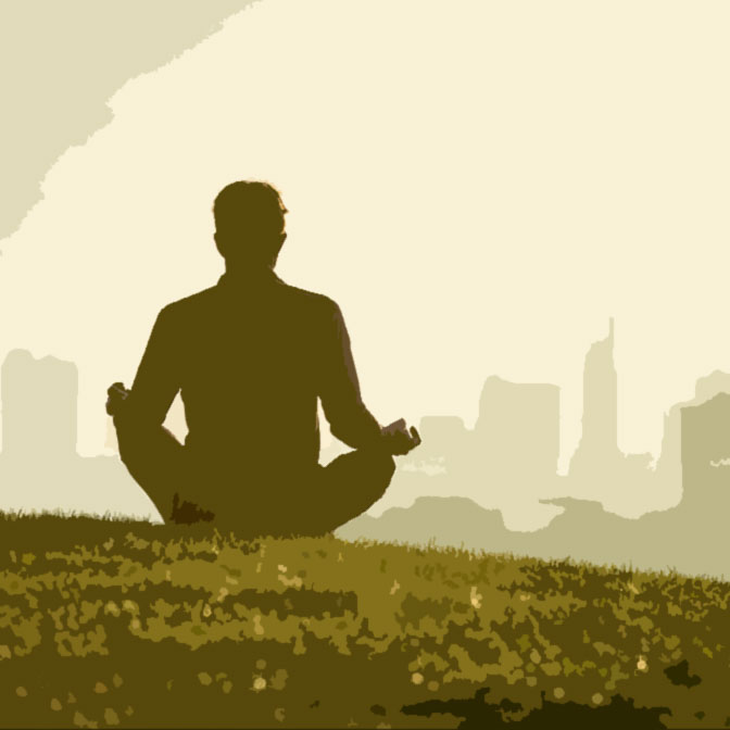 man meditates in park overlooking city