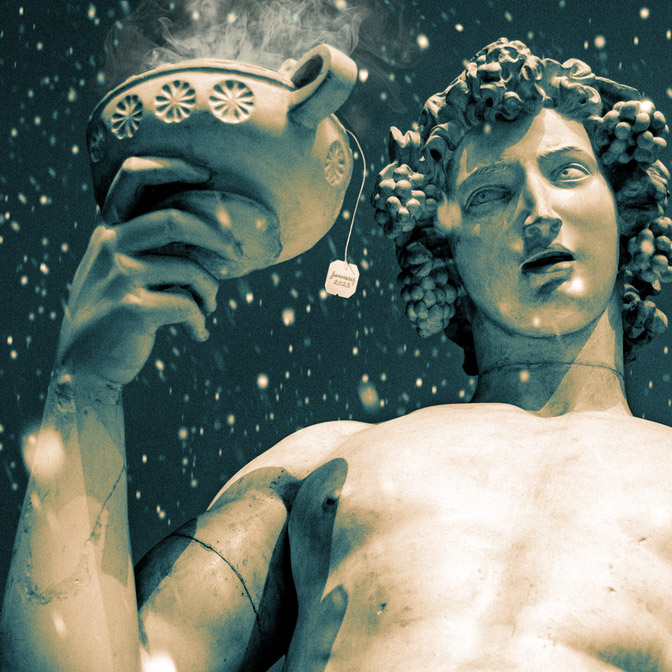 close up of Dionysus sculpture in the snow, the wine cup he's holding is steaming with a tea bag tag hanging from it