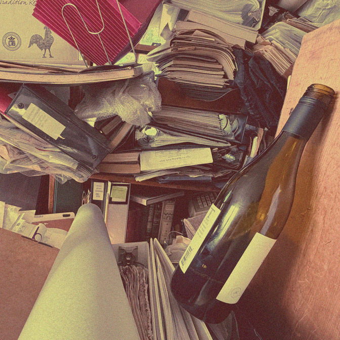 Cluttered home interior with papers and bottles, illustrating substance abuse disorder and co-occurring mental health challenges, representing integrated substance abuse therapy in Massachusetts at Handel Behavioral Health.