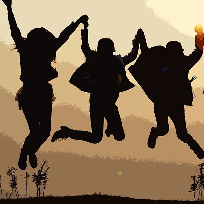 three silhouetted people jumping